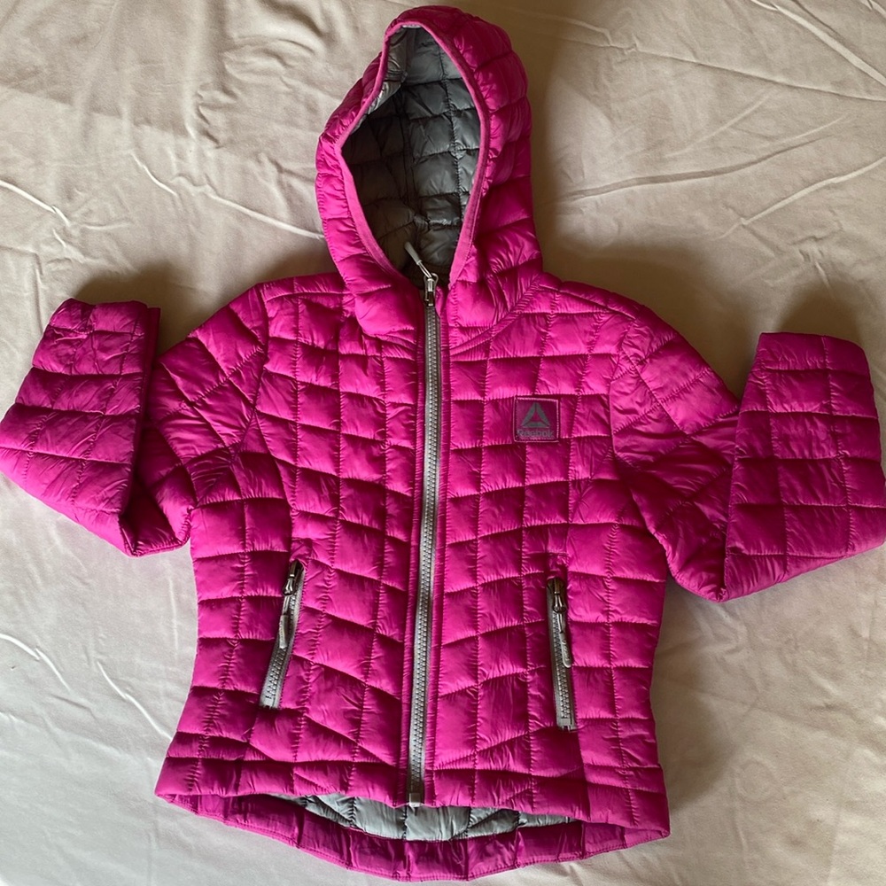 Size 5/6 Reebok winter jacket. Pink with two zip pockets and hood.